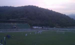 Pelister players celebrate their win while their fans watched the match from a hill due to a stadium suspension