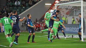 Ferhan Hasani (green jersey in front of Mainz goal) is challenged by Nikolche Noveski (#4); photo: espnstar.com 